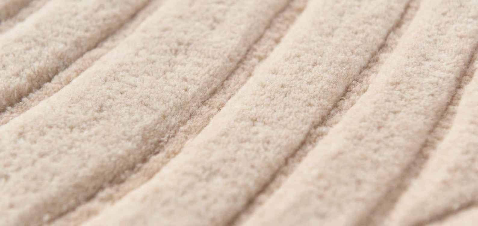 Beige Close view Desert Wool Rug showing sculpted flowing lines.